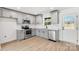 Bright kitchen featuring gray cabinetry, stainless steel appliances, and a subway tile backsplash at 219 E Rice St, Landis, NC 28088