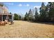 Expansive backyard space with a screened-in porch, outdoor seating, and a modern fire pit at 2205 Meleto Dr, Waxhaw, NC 28173