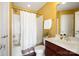 Bathroom featuring a white shower curtain, brown vanity and a white toilet at 2205 Meleto Dr, Waxhaw, NC 28173