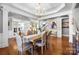 Elegant dining room with chandelier, hardwood floors and decorative trim at 2205 Meleto Dr, Waxhaw, NC 28173