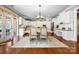 Bright kitchen and breakfast nook with white cabinetry, modern appliances, and stylish dining set at 2205 Meleto Dr, Waxhaw, NC 28173