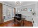 Bright office featuring hardwood floors, modern lighting, white cabinets, and large windows with plantation shutters at 2205 Meleto Dr, Waxhaw, NC 28173