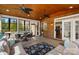 Bright sunroom with brick accent wall, wood ceiling, large windows, and comfortable seating at 2205 Meleto Dr, Waxhaw, NC 28173