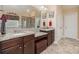 Well-lit bathroom with double vanity, large mirror, and tiled shower area at 2605 Lakefront Dr, Belmont, NC 28012