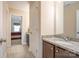 Bathroom with granite countertops, dark wood vanity and a view to a carpeted bedroom at 2605 Lakefront Dr, Belmont, NC 28012