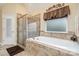 Luxurious bathroom with a large soaking tub, glass enclosed shower, and tiled walls at 2605 Lakefront Dr, Belmont, NC 28012