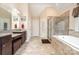 A bright bathroom with double vanity, tiled shower, and a soaking tub at 2605 Lakefront Dr, Belmont, NC 28012