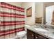 Bathroom features a granite countertop, dark wood vanity, and a striped shower curtain at 2605 Lakefront Dr, Belmont, NC 28012