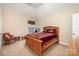 Bedroom with a vaulted ceiling, carpeted floor, and traditional wood furniture at 2605 Lakefront Dr, Belmont, NC 28012