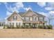 Charming two-story home with stylish design elements and a well-manicured lawn under a beautiful blue sky at 2605 Lakefront Dr, Belmont, NC 28012