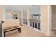 Upstairs hallway features carpet, a bench, and a view overlooking the living room at 2605 Lakefront Dr, Belmont, NC 28012