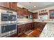 Gourmet kitchen with stainless steel appliances, custom cabinets, and granite counters at 2605 Lakefront Dr, Belmont, NC 28012