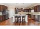 Kitchen with stainless steel appliances, granite countertops, and island with stools at 2605 Lakefront Dr, Belmont, NC 28012