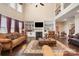 Elegant living room featuring a fireplace, built-in shelving, high ceilings and large windows at 2605 Lakefront Dr, Belmont, NC 28012