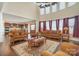 Open-concept living room flowing into the kitchen, featuring hardwood floors and large windows at 2605 Lakefront Dr, Belmont, NC 28012