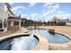 Beautiful backyard pool with stone waterfall features and ample lounging space at 2605 Lakefront Dr, Belmont, NC 28012