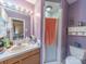 Purple bathroom featuring a shower with glass door, a toilet, and a vanity with a sink at 3021 Whitson Rd, Gastonia, NC 28054