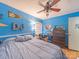 Bright blue bedroom with hardwood floors, a ceiling fan, and natural light from the window at 3021 Whitson Rd, Gastonia, NC 28054