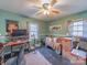 Green bedroom with a desk, hardwood floors, a ceiling fan, and natural light from the windows at 3021 Whitson Rd, Gastonia, NC 28054