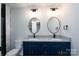 Modern bathroom with double vanity, granite countertop, and stylish round mirrors at 320 Cabarrus W Ave, Concord, NC 28025