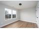 Bright bedroom with wood-look flooring, base trim, two windows, and a ceiling light at 320 Cabarrus W Ave, Concord, NC 28025