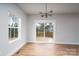 Dining room with a modern chandelier, sliding glass doors to a wooden deck, and ample natural light at 320 Cabarrus W Ave, Concord, NC 28025