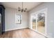 Bright dining area featuring wood floors, modern light fixture, sliding glass doors to deck at 320 Cabarrus W Ave, Concord, NC 28025