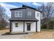 Charming two-story home featuring a covered porch and modern black and white exterior at 320 Cabarrus W Ave, Concord, NC 28025