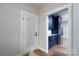 Kitchen featuring a stainless steel refrigerator, wood-look flooring, granite countertops, and navy blue cabinets at 320 Cabarrus W Ave, Concord, NC 28025