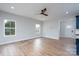 Open-concept living room with hardwood floors, ceiling fan, and plenty of natural light at 320 Cabarrus W Ave, Concord, NC 28025