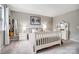 Bedroom with stylish decor, white furniture and a guitar on the wall at 3224 Heathstead Pl, Charlotte, NC 28210