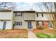 Inviting townhouse featuring tidy front yard, neutral siding, black shutters, and a welcoming blue front door at 3224 Heathstead Pl, Charlotte, NC 28210