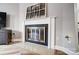 A living room showing a fireplace with a black and brass screen set against a white mantel at 3224 Heathstead Pl, Charlotte, NC 28210