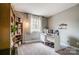 Functional home office with a bookcase, natural light and a white desk for organization at 3224 Heathstead Pl, Charlotte, NC 28210