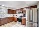 A lovely kitchen featuring stainless steel appliances, subway tile backsplash and warm brown wooden cabinets at 3224 Heathstead Pl, Charlotte, NC 28210