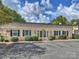 Attractive clubhouse featuring brick exterior, dark shutters, manicured landscaping, and ample parking at 3504 Colony Rd # R, Charlotte, NC 28211