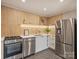 Modern kitchenette features stainless steel appliances, quartz counters, and tile backsplash at 3504 Colony Rd # R, Charlotte, NC 28211