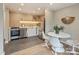 Kitchenette with stainless steel appliances, modern backsplash, and adjacent dining area at 3504 Colony Rd # R, Charlotte, NC 28211