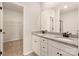 Bathroom features a double vanity with granite countertop, white cabinets and a large mirror at 3516 Narrow Ln, Charlotte, NC 28215