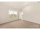 Bright bedroom with neutral carpet, a large window, and ample natural light at 3516 Narrow Ln, Charlotte, NC 28215