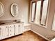 Bright bathroom with double sinks, neutral tile floor, and a window bench at 3580 5Th Ne St, Hickory, NC 28601