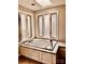 A luxurious soaking tub is set against a backdrop of bright windows with a skylight above at 3580 5Th Ne St, Hickory, NC 28601