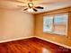 This cozy bedroom features hardwood floors, a ceiling fan, and a large window for natural light at 3580 5Th Ne St, Hickory, NC 28601