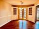 Cozy dining room featuring classic built-in cabinets, hardwood floors, and views through glass doors to the exterior at 3580 5Th Ne St, Hickory, NC 28601