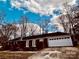 A brick home with an attached garage sits against a backdrop of blue sky and fluffy clouds at 3580 5Th Ne St, Hickory, NC 28601