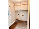 Cozy laundry room with tiled floor and upper cabinets at 3580 5Th Ne St, Hickory, NC 28601