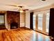 Spacious living room with a brick fireplace and French doors at 3580 5Th Ne St, Hickory, NC 28601