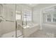 Bathroom featuring a shower, soaking tub, and window with natural lighting at 41062 Calla Lily St, Fort Mill, SC 29707