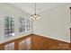 Open dining area with wood flooring, chandelier lighting and outdoor access; excellent for hosting meals at 41062 Calla Lily St, Fort Mill, SC 29707