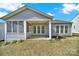 Exterior of the home featuring a screened-in porch and view of backyard at 41062 Calla Lily St, Fort Mill, SC 29707